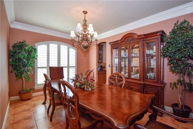 5914 Beauvais Dr, Corpus Christi, TX 78414 - dining room featuring light tile patterned floors, a notable chandelier, baseboards, and ornamental molding