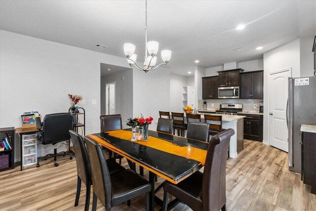 2673 Abbey Rd, Corpus Christi, TX 78415 - dining area with a chandelier, light wood-style floors, and recessed lighting