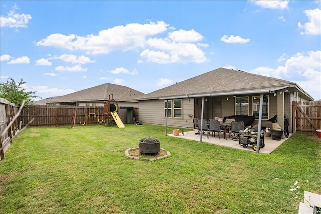 2673 Abbey Rd, Corpus Christi, TX 78415 - back of property featuring a fire pit, a patio, a playground, and a shingled roof