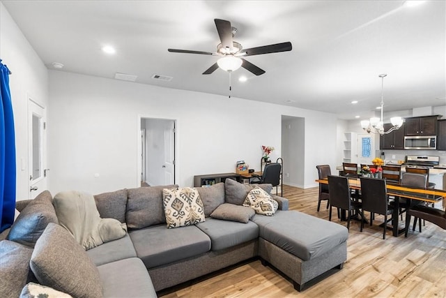 2673 Abbey Rd, Corpus Christi, TX 78415 - living room featuring a chandelier, light wood-type flooring, a ceiling fan, and recessed lighting