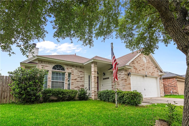 ranch-style home with a garage and a front yard