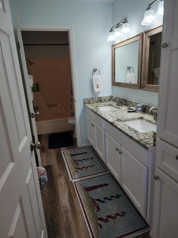2292 N Fulton Beach Rd, Rockport, TX 78382 - bathroom with wood finished floors, double vanity, toilet, and  shower combination