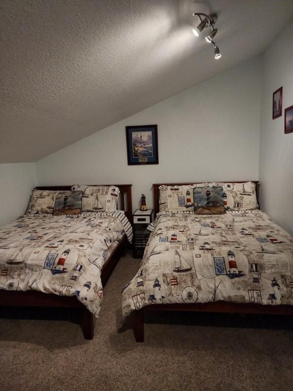 2292 N Fulton Beach Rd, Rockport, TX 78382 - carpeted bedroom featuring vaulted ceiling and a textured ceiling