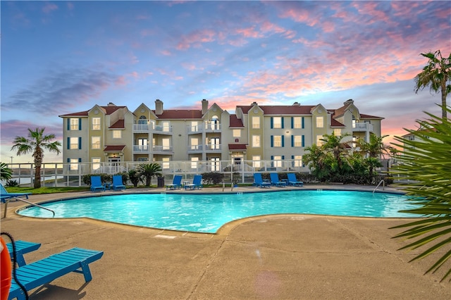 view of pool at dusk