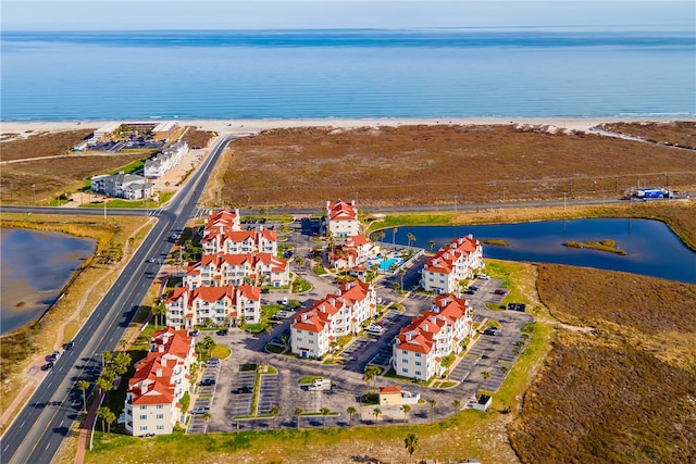 drone / aerial view with a water view and a view of the beach