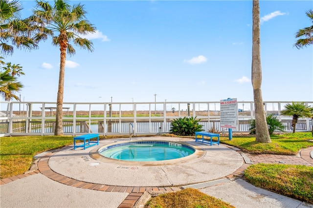 view of pool featuring a water view and a community hot tub