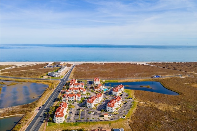 bird's eye view with a water view and a view of the beach