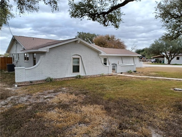 exterior space with cooling unit and a lawn