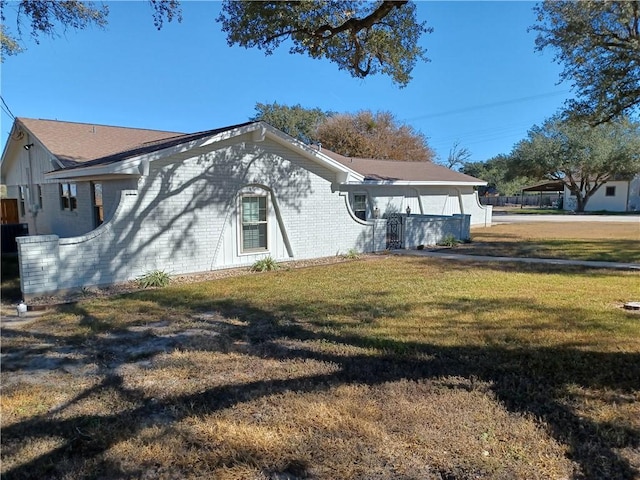 view of side of property with a yard