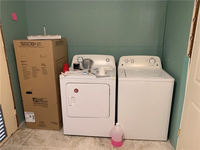 laundry room featuring washing machine and clothes dryer