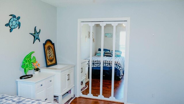 719 E King St, Rockport, TX 78382 - bedroom featuring dark wood-style flooring