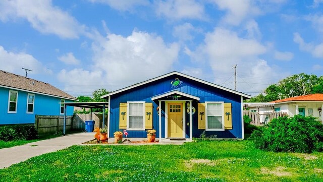 719 E King St, Rockport, TX 78382 - bungalow-style house with an attached carport and concrete driveway