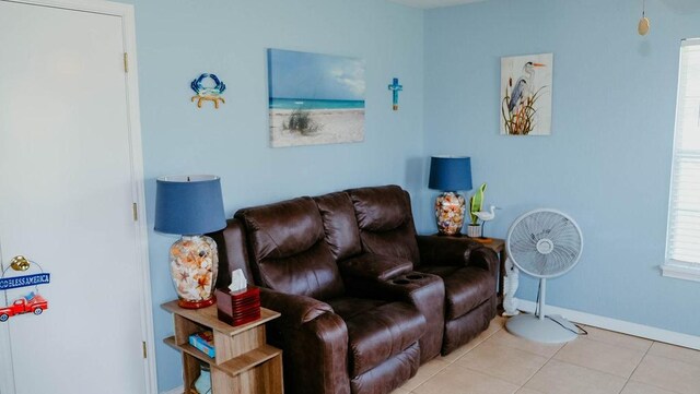 719 E King St, Rockport, TX 78382 - tiled living room featuring baseboards