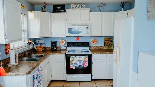 719 E King St, Rockport, TX 78382 - kitchen featuring white appliances, a sink, white cabinetry, and light tile patterned floors