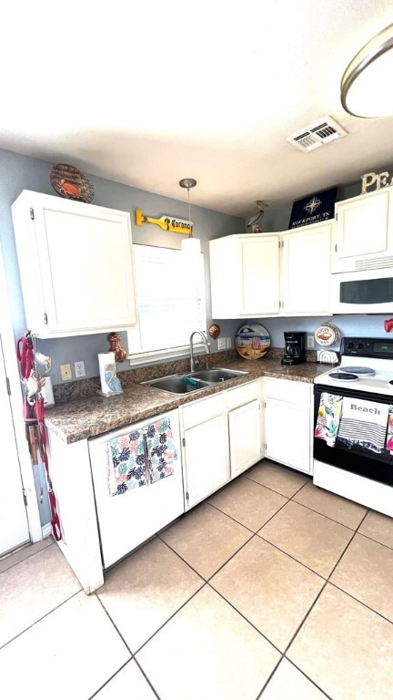 kitchen featuring a sink, white appliances, white cabinetry, and visible vents
