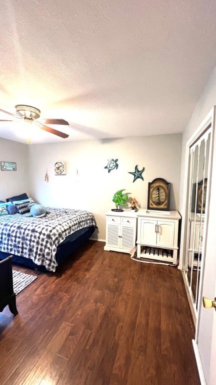bedroom featuring a ceiling fan, a textured ceiling, and wood finished floors