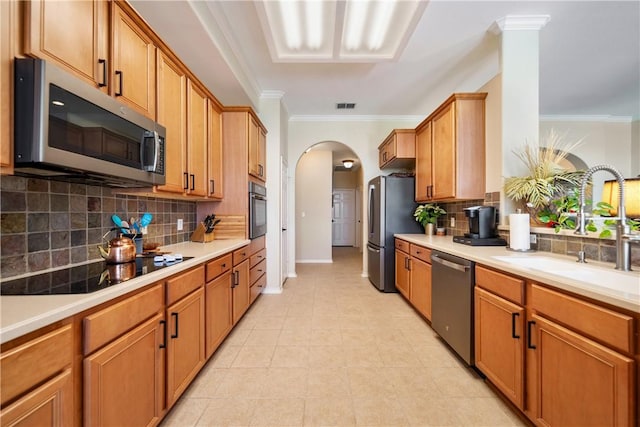 6217 Garden Ct, Corpus Christi, TX 78414 - kitchen featuring black appliances, arched walkways, a sink, backsplash, and ornamental molding