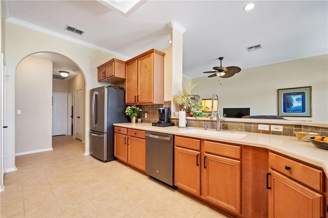 6217 Garden Ct, Corpus Christi, TX 78414 - kitchen featuring stainless steel appliances, a sink, a ceiling fan, tasteful backsplash, and crown molding