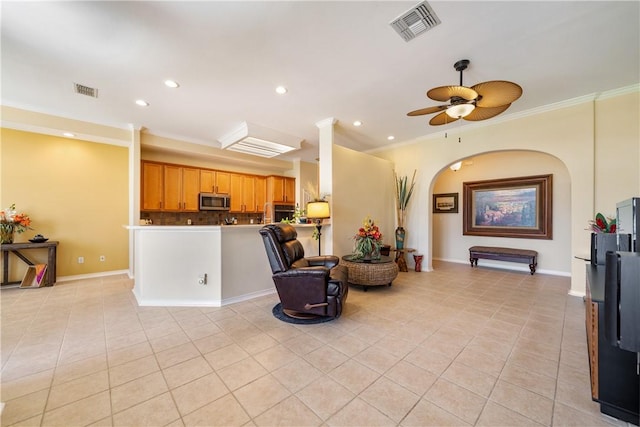 6217 Garden Ct, Corpus Christi, TX 78414 - living room with light tile patterned flooring, a ceiling fan, ornamental molding, arched walkways, and recessed lighting