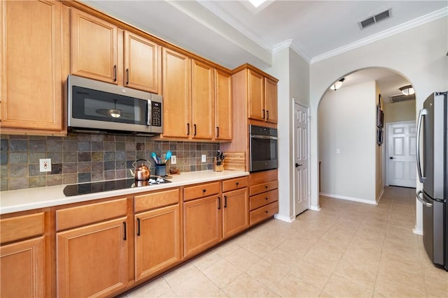 6217 Garden Ct, Corpus Christi, TX 78414 - kitchen with appliances with stainless steel finishes, arched walkways, tasteful backsplash, ornamental molding, and light countertops