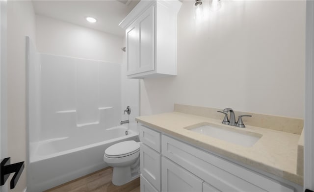 full bathroom with shower / bathing tub combination, hardwood / wood-style floors, vanity, and toilet