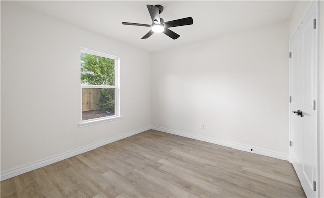 empty room featuring light wood-type flooring and ceiling fan