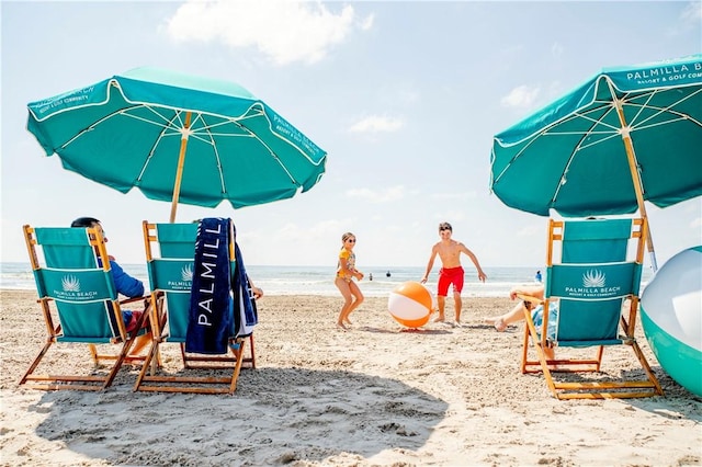 view of play area featuring a water view and a view of the beach