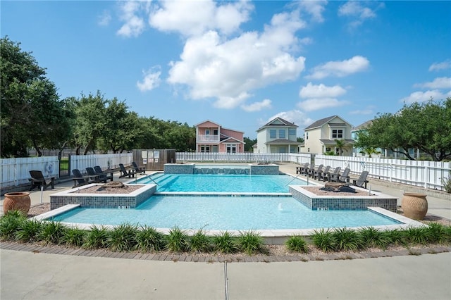 view of swimming pool featuring pool water feature and a patio