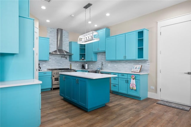 kitchen with a center island, high end stainless steel range oven, wall chimney range hood, dark hardwood / wood-style flooring, and pendant lighting