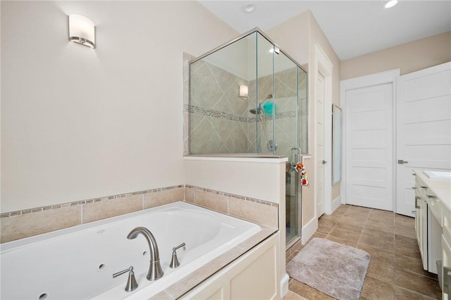 bathroom with tile patterned floors, vanity, and separate shower and tub