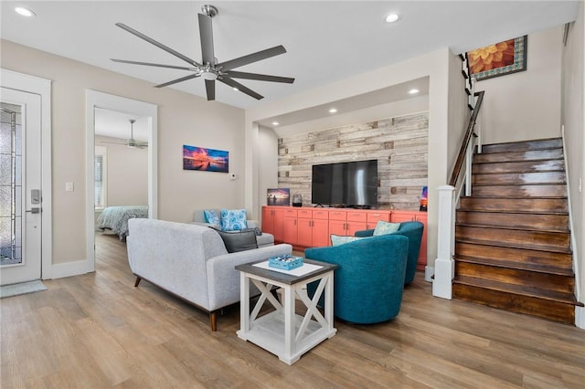 living room featuring ceiling fan and light hardwood / wood-style flooring