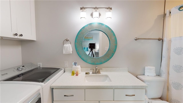 full bath with independent washer and dryer, vanity, and toilet