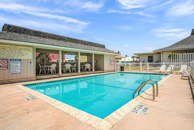 pool featuring fence and a patio