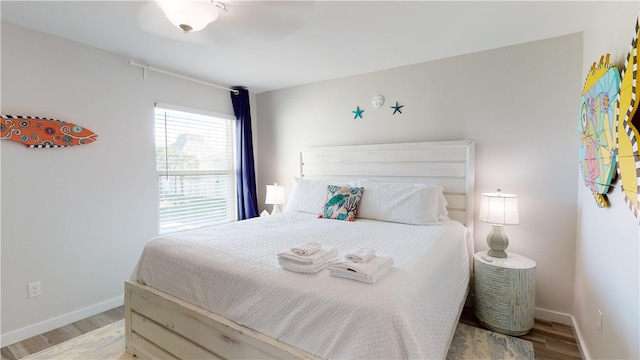 bedroom with baseboards and light wood finished floors