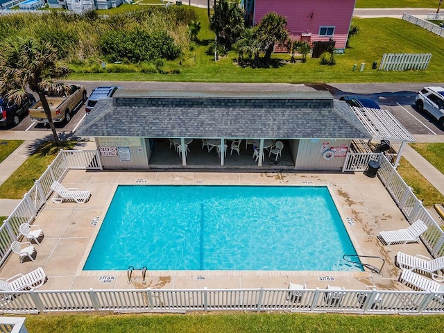 community pool featuring a patio area and fence