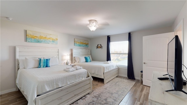 bedroom with wood finished floors and baseboards