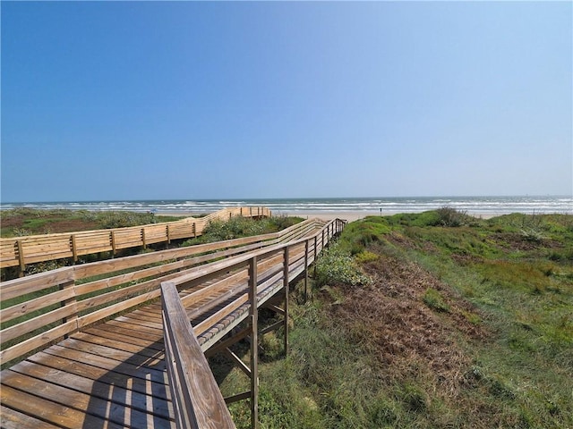 surrounding community with a beach view and a water view