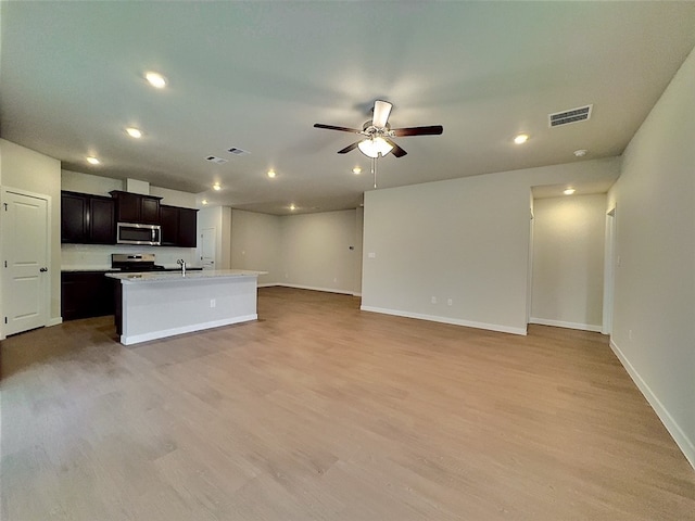 3014 Stone Creek Dr, Corpus Christi, TX 78410 - unfurnished living room featuring a ceiling fan, light wood-style flooring, recessed lighting, baseboards, and a sink