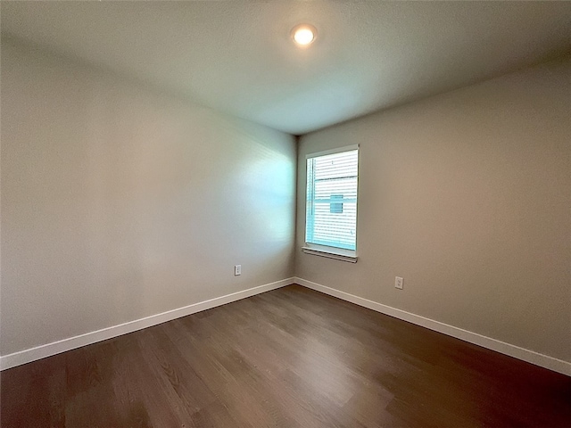 3014 Stone Creek Dr, Corpus Christi, TX 78410 - unfurnished room featuring baseboards and dark wood-style flooring