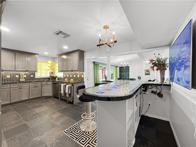 130 Alta Plz, Corpus Christi, TX 78411 - kitchen with a chandelier, stainless steel dishwasher, dark countertops, decorative backsplash, and recessed lighting