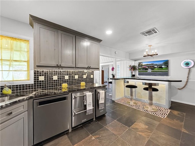130 Alta Plz, Corpus Christi, TX 78411 - kitchen featuring dishwasher, a chandelier, decorative backsplash, stone tile floors, and recessed lighting