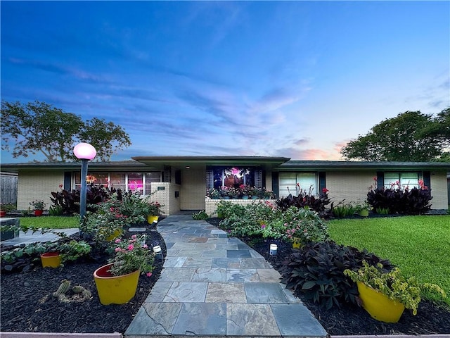 130 Alta Plz, Corpus Christi, TX 78411 - single story home featuring brick siding, a front lawn, and a garage