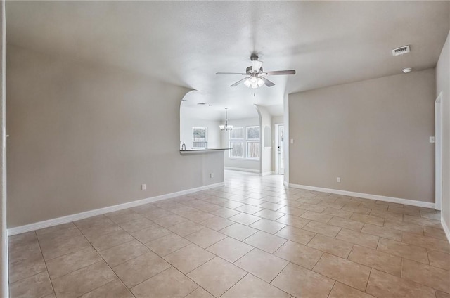 4384 Summer Wind Dr, Corpus Christi, TX 78413 - unfurnished living room featuring a ceiling fan, light tile patterned floors, and a chandelier