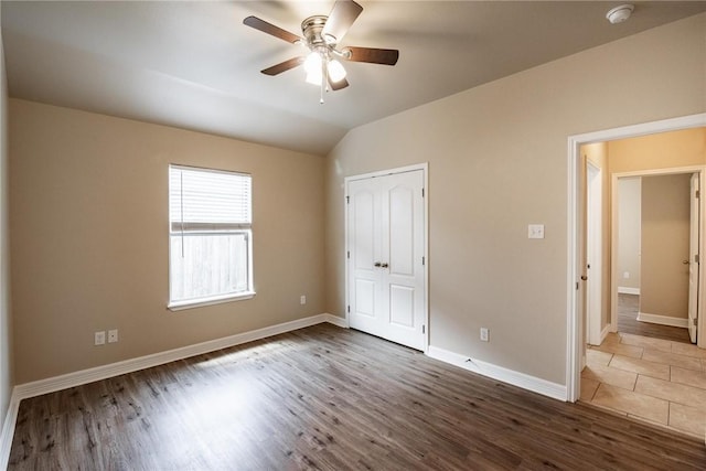 4384 Summer Wind Dr, Corpus Christi, TX 78413 - unfurnished bedroom featuring wood finished floors, vaulted ceiling, a closet, and ceiling fan