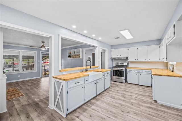 1006 Vernon Dr, Corpus Christi, TX 78407 - kitchen with stainless steel gas range oven, wood counters, a sink, light wood-style flooring, and recessed lighting
