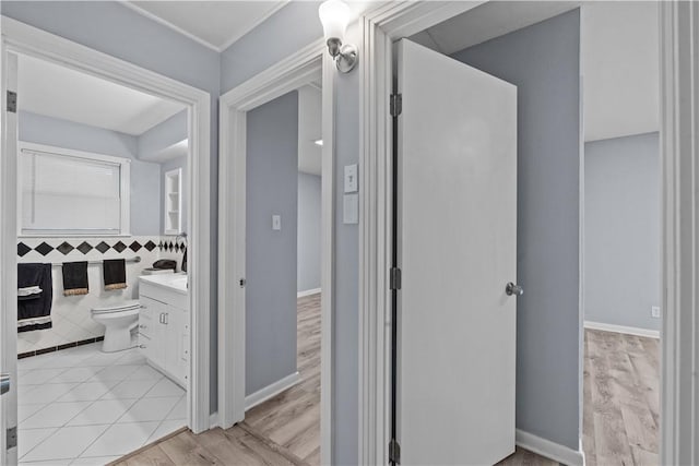 1006 Vernon Dr, Corpus Christi, TX 78407 - hallway featuring tile walls and light wood finished floors