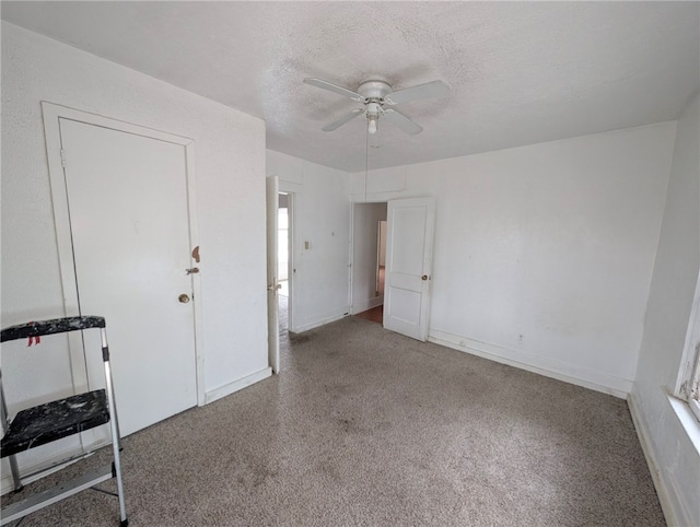 empty room with a ceiling fan and a textured ceiling