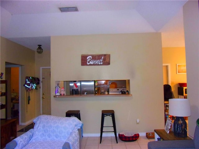 tiled bedroom featuring visible vents and stainless steel refrigerator with ice dispenser