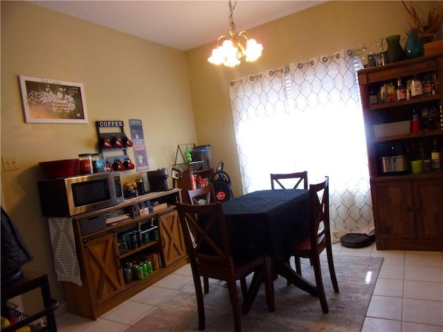 dining room featuring light tile patterned floors and an inviting chandelier