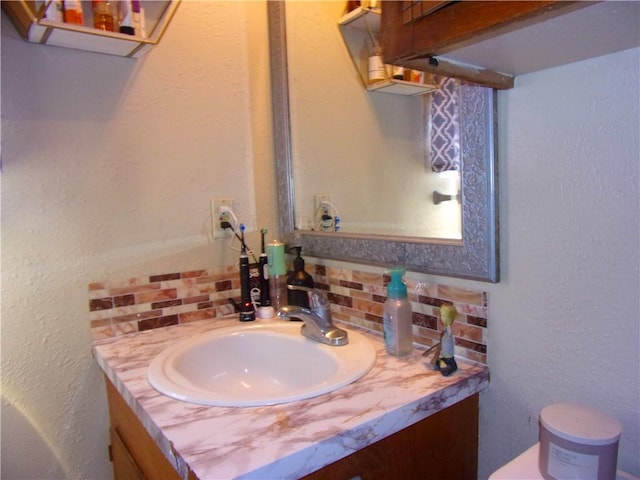 half bathroom with decorative backsplash and vanity